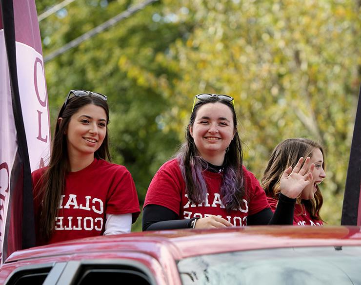 Students from Clark College wave in the Homecoming Parade